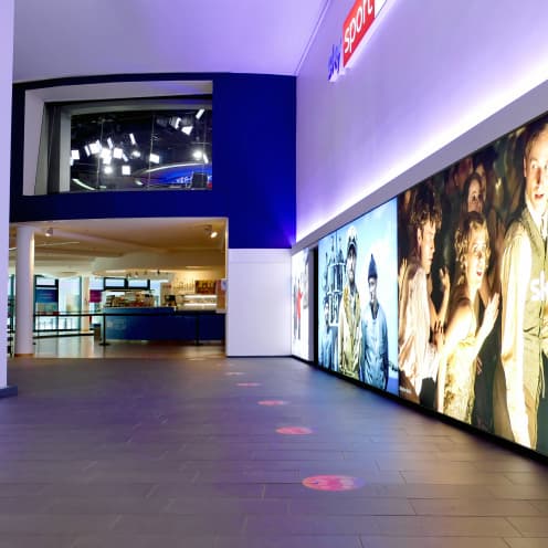 shot of inside Sky office with wall length visual display