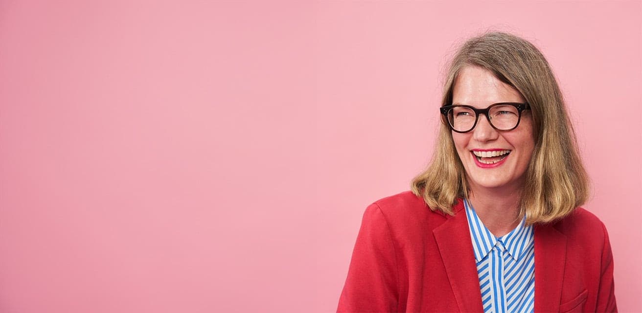 woman wearing glasses and laughing